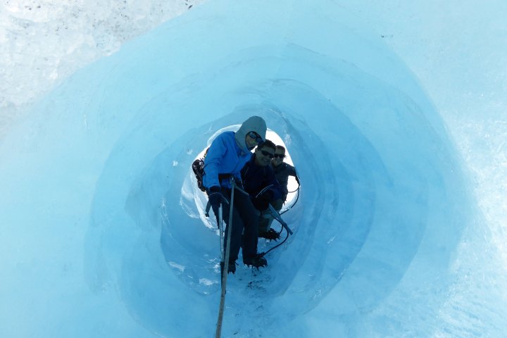 a man riding a snowboard down a snow covered mountain