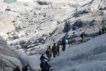 a group of people walking across a snow covered mountain