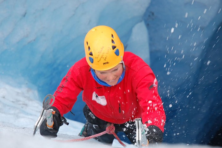 a young boy riding a snow board